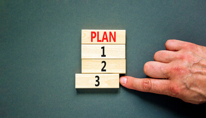 Time to plan 3 symbol. Concept word Plan 1 2 3 on wooden block. Businessman hand. Beautiful grey table grey background. Business planning and time to plan 3 concept. Copy space.