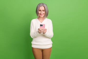 Sticker - Photo of senior lady grey hair using smartphone wear white pullover writing family group chat viber isolated on green color background