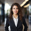 © Aimages - Portrait of young smiling african american woman looking at camera with crossed arms. Happy girl standing Successful businesswoman