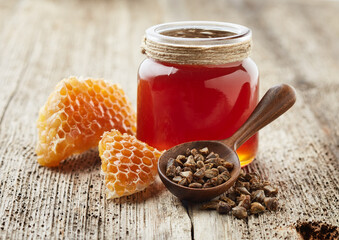 Poster - Propolis with honey on old wooden background