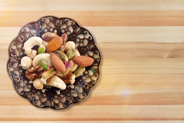 Canvas Print - mixed tasty nuts in bowl on the desk