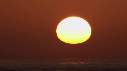 Wall Mural - beautiful evening sunset with big sun in the atlantic ocean at portugal coast