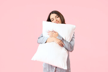 Sticker - Young woman in pajamas with pillow on pink background