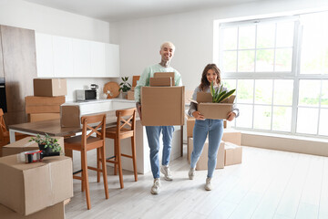 Sticker - Young couple with cardboard boxes in kitchen on moving day