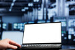 © DC Studio - Close up shot of mock up laptop used by proficient repairman in data center using server cabinets to deliver massive computing power, control network resources, process and store datasets
