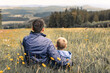 © kieferpix - Parent and child father son embrace in autumn meadow, showing love and togetherness.