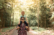 © kieferpix - Happy Family father gives son a piggyback walking in the woods enjoying adventure exploring nature