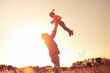 © kieferpix - Father and child having fun playing outdoors in nature sunset sky showing happiness, love, togetherness
