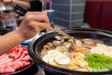 Canvas Print - Hotpot with fresh slice of meat and food in restaurant