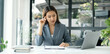 © Orathai - Asian businesswomen sit at their desks and calculate financial graphs showing results about their investments, planning successful business growth process