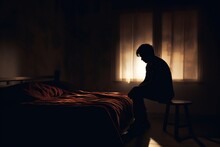Silhouette Depressed Man Sadly Sitting On The Bed In The Bedroom. Sad Asian Man Suffering Depression Insomnia Awake And Sit Alone On The Bed In Bedroom. Depression Health People Concept.