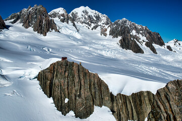 Wall Mural - Flying  over the tallest snow covered peaks of the Southern alps in a helicopter with no windows