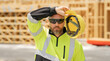 Tired, overworked worker in building uniform on buildings construction background. Builder at the construction site. Man worker with helmet on construction site. American bilder in hardhat.