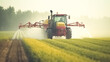A tractor sprays an agricultural field with fertilizer.