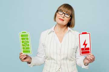 Wall Mural - Minded employee business woman 50s wear white classic suit glasses formal clothes hold in ahnd card sign of battery green red charge isolated on plain light blue background Achievement career concept