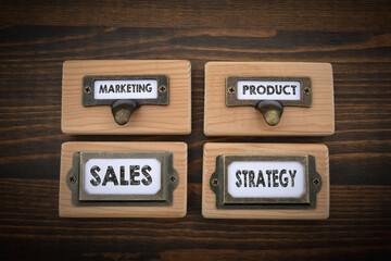 Canvas Print - marketing sales product strategy concept. file cabinet label. wood texture background