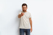 © Daria - Indignant man standing over white background pointing displeased and angry to you on camera