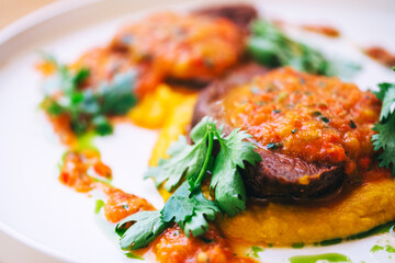 two pieces of beef chop with sauce in a cafe. beef cuts of meat with tomato sauce in a restaurant