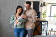 © NDABCREATIVITY - Peaceful young married couple enjoying being family, parents, holding new born baby in arms