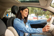 © mimagephotos - young woman driving car