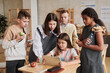 © Mediaphotos - Diverse group of school children using digital tablet in classroom during break