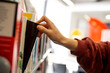 © Austockphoto - student at the library choosing a book from shelf
