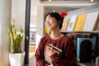 © Austockphoto - Young adult asian female student at the library
