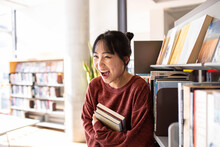 Young Adult Asian Female Student At The Library