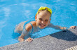 © evgeniia_1010 - Smiling cute little girl wearing swimming glasses in the pool on a sunny summer day.