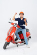 © 1112000 - full body photo of a man wearing a hairdresser and driving a motorbike