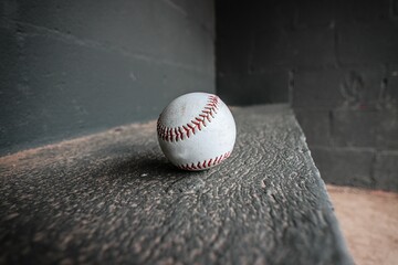 Sticker - Close up of a baseball resting in the corner of a bench