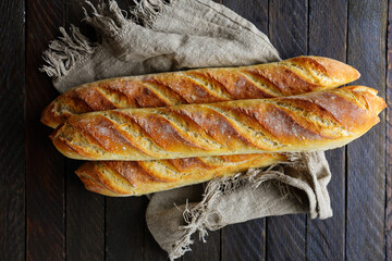 Canvas Print - fresh baguette on napkin bread top view