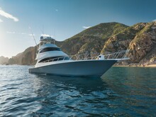 Elegant Sportfishing Yacht In The Ocean In Cabo, Mexico Sailing Leisurely Through A Tranquil Bay