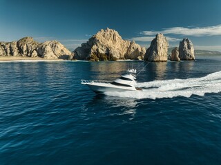 Poster - Elegant sportfishing yacht in the ocean in Cabo, Mexico sailing leisurely through a tranquil bay