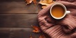 © OP38Studio - Autumn composition with leaves and a Cup of tea on a wooden background. The concept of autumn, knit sweaters, scarves, perfect for chilly autumn days, generative ai