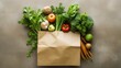 Variety of fresh vegetables in a brown paper bag