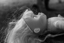 Creepy Doll With Long White Hair Lies On The Ground