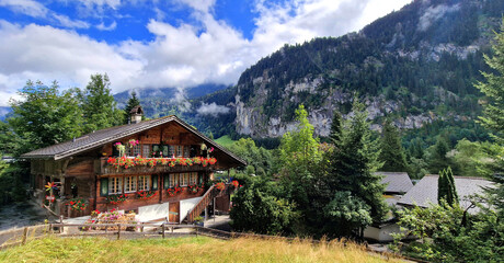 Wall Mural - Switzerland travel . most scenic places. beautiful Lauterbrunnen village and valley surrounded by impressive Alps mountains with traditional wooden houses