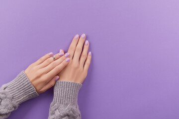 Wall Mural - Womans hands with fashionable lavender manicure. Winter christmas nail design