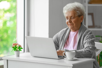 Sticker - Senior woman using laptop at home