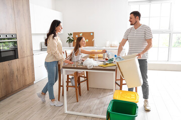 Wall Mural - Family sorting plastic garbage in kitchen