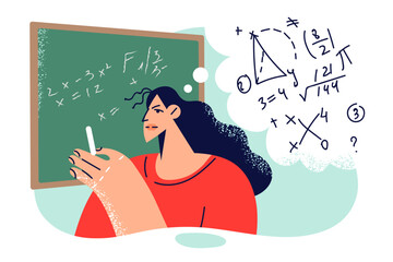 Woman teacher writes mathematical formulas on blackboard to teach students algebra