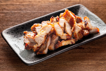 Wall Mural - tasty slice fried pork in rectangular ceramic plate on rustic natural wood texture background