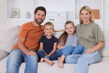 Wall Mural - Portrait of happy family with children on sofa at home