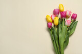 Fototapeta Tulipany - Beautiful colorful tulip flowers on beige background, flat lay. Space for text