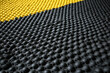 © aicandy - An up-close view of industrial safety mats made of durable rubber and featuring raised bumps for better grip and anti-slip protection