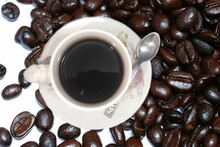 Black Coffee In A White Cup With Stainless Steel Spoon