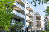 Fototapeta Londyn - Modern apartment buildings surrounded by greens seen in Berlin, Germany