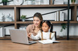 © Patcharanan - Mother teaching daughter homework lesson at home preschool student. Teaching children learning in the house education.