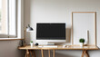 © GenZ_Pro - A creative workspace featuring a desktop computer and a white work table with an empty poster frame